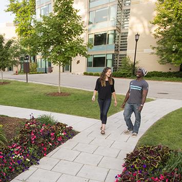 Students walk through the Oaks Circle, on the residential side of campus.